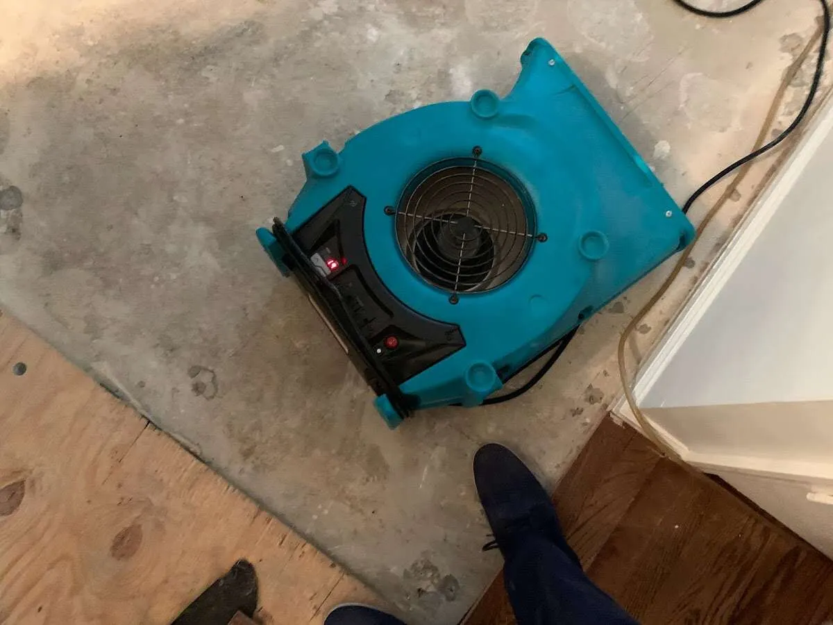 Air mover drying subfloor during Commercial Water Damage Restoration in Lewisburg